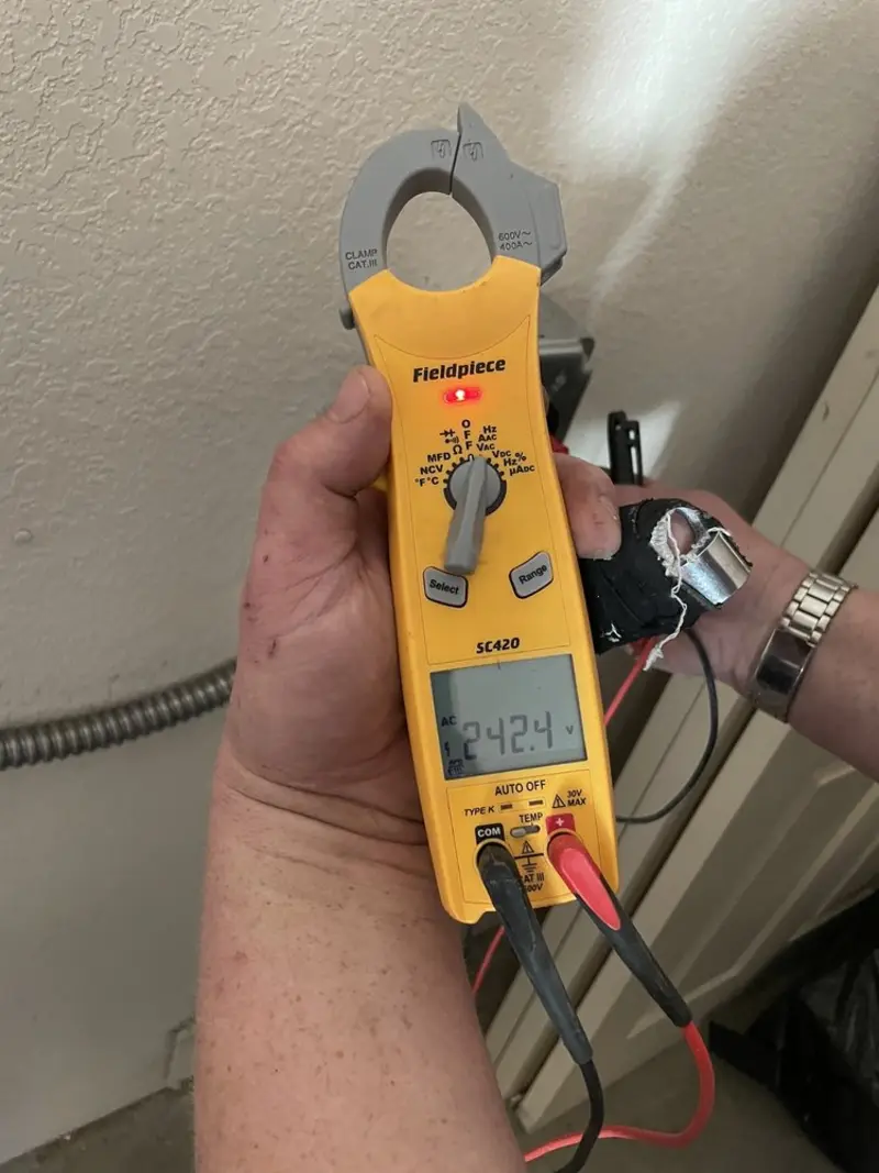 Voltage testing with clamp meter during Outlet Installation in Rogers